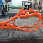 An Orange KTM Motorcycle frame.